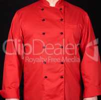 fragment of a red uniform with black buttons on the chef