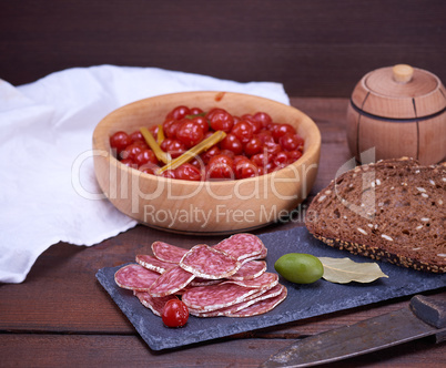 sliced smoked salami sausages and pieces of rye bread