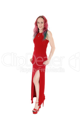 Slim woman standing in a red evening dress