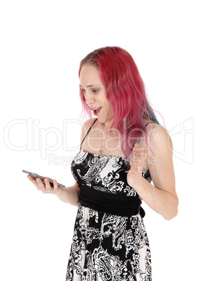 Woman is shocked looking at her cell phone