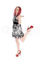 Young woman dancing in a dress and heels