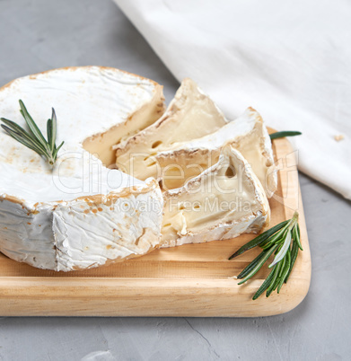 round brie cheese on a wooden board