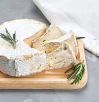 round brie cheese on a wooden board