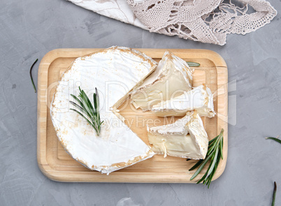 round brie cheese on a wooden board