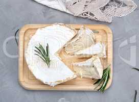 round brie cheese on a wooden board