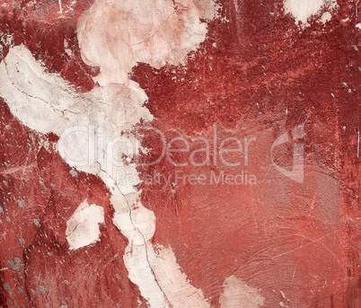 fragment of a red cracked cement wall