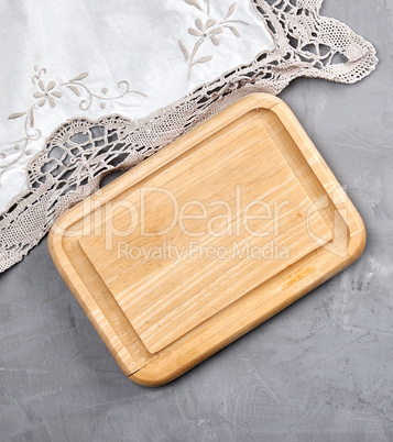 empty wooden cutting board on gray cement background