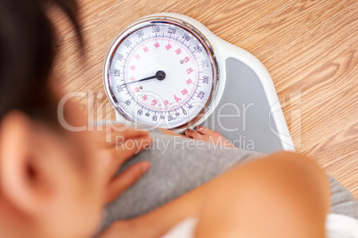 Healthy Female Woman Weighing Herself on Scales