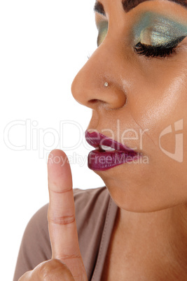 Close up of woman face with finger on mouth