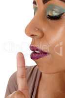 Close up of woman face with finger on mouth