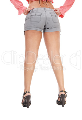 Woman standing from back in shorts with long legs