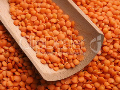 Organic red lentils on a wooden table