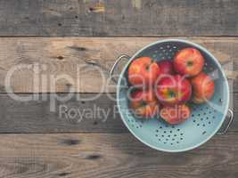 Organic apples in an old colander