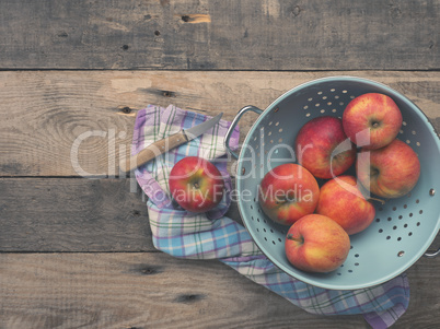 Organic apples in an old colander