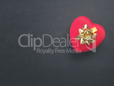 Heart shaped gift box with a golden bow