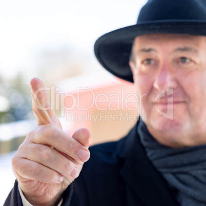 Finger pointing of man with hat