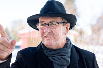 Finger pointing of man with hat