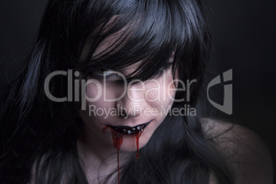 Female zombie with blood in her mouth
