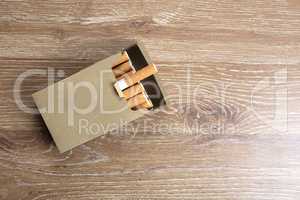Pack of cigarettes on a wooden background