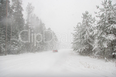 Beautiful winter landscape with snowy road in the winter forest.