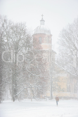 Winter landscape with snow covered church and trees.