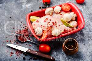 Raw chicken in baking dish