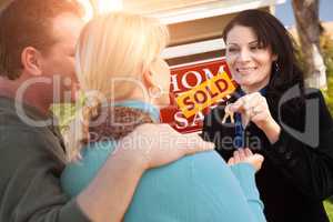 Hispanic Female Real Estate Agent Handing Over New House Keys