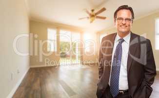 Handsome Male Wearing Suit and Tie In Empty Room of House