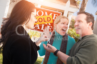 Hispanic Female Real Estate Agent Handing Over New House Keys