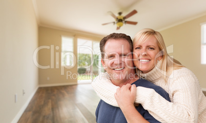 Happy Caucasian Young Adult Couple In Empty Room of House
