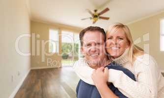 Happy Caucasian Young Adult Couple In Empty Room of House