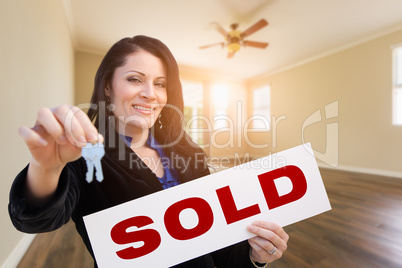 Hispanic Woman With House Keys and Sold Real Estate Sign