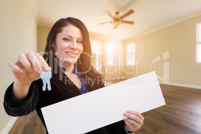 Hispanic Woman With House Keys and Blank Sign In Empty Room