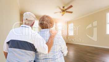 Senior Couple Looking Into Empty Room of House