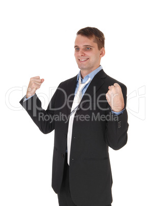 Happy business man standing with fists lifted up