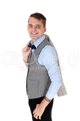 Young man standing whit his jacket over shoulder