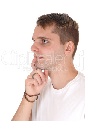 Happy young man standing with finger on mouth