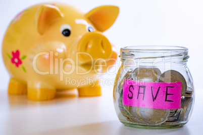 Piggy bank and glass with coins