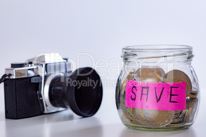Photo camera and glass with coins
