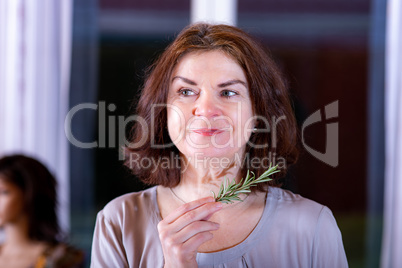 Woman with rosemary branch