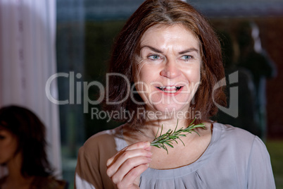 Woman with rosemary branch