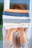 Woman carries towels