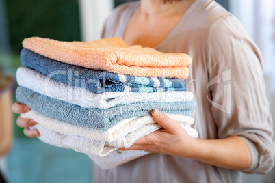 Woman carries towels