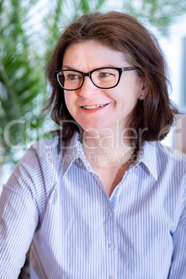 Woman with glasses in middle age