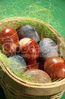 Painted eggs on green background.