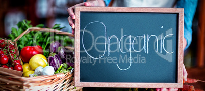 Female staff holding organic sign board