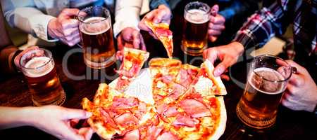 Friends with beer mug and pizza in bar