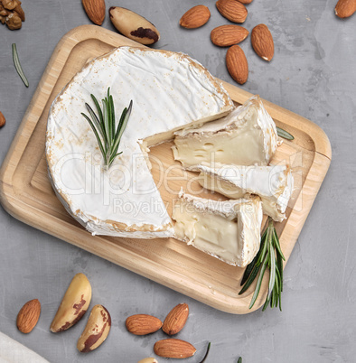 round brie cheese on a wooden board