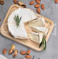 round brie cheese on a wooden board