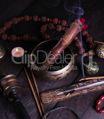 copper singing bowl and a wooden stick